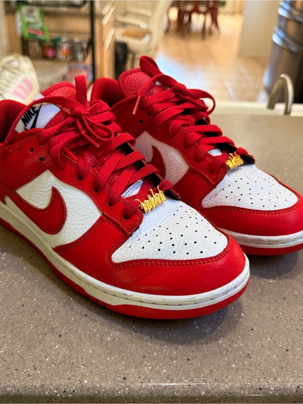 Nike Red and White Low-Top sneakers.  Pink Nike at heel and gold emblem